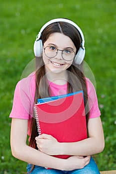 Audio listening and study. Happy child enjoy listening to music. Small girl practise listening skills. Listening course