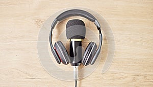 Audio, microphone and headphones on a table for a podcast, radio or broadcast. Music, above or musical gear, equipment