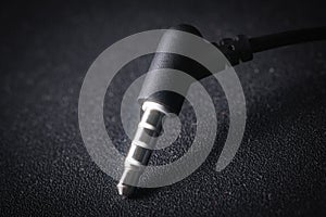 Audio Mini Jack plug on black background