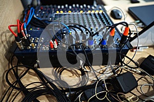 Audio mixer in a recording studio. Panel with wires and plugs