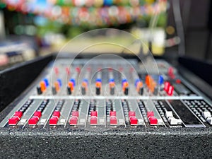 audio mixer soundboard. The mixing console features several rows