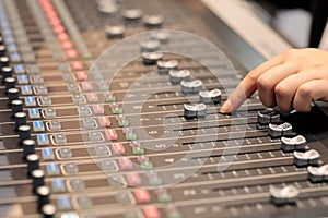 Audio mixing console with hand of sound engineer