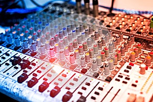 An Audio mixing table in soft light