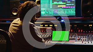 Audio technician working with music recording software and editing tunes