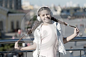 Audio tour headphones gadget. City guide and audio tour. Girl little tourist kid explore city using audio guide