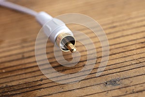White audio-video analog cable on an old wood table background