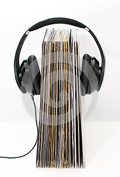 Audiobooks album vinyl concept. Headphones put over book and white background