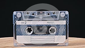 Audiocassette Rotates on Black Background Close-Up