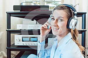 Audiophile woman enjoying music in her home