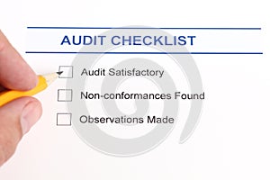 Audit checklist and hand with pencil photo