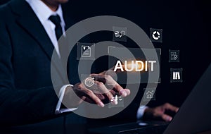 Audit concept with icons, Businessman working with computer and touching on word audit on virtual screen. Check to examine