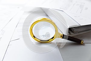 Audit concept - magnifying glass and business documents