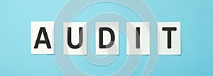 Audit text on white paper on a blue background, Business Concept.