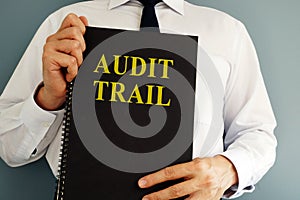 Audit trail concept. Auditor holding book.