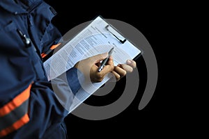 An auditor or inspector holds a clipboard and checklist of assessments