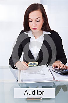 Auditor scrutinizing financial documents