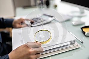 Auditor Using Magnifying Glass For Audit