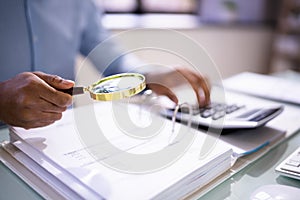 Auditor Using Magnifying Glass For Audit