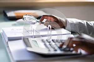 Auditor Using Magnifying Glass For Audit