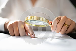 Auditor Using Magnifying Glass For Audit