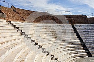 Auditorium of the Roman Odeon Patra Romaiko Odio Patras in Greece with a morning shadow with blue sky photo