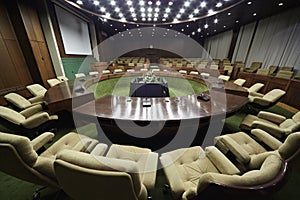 Auditorium with round table and armchairs