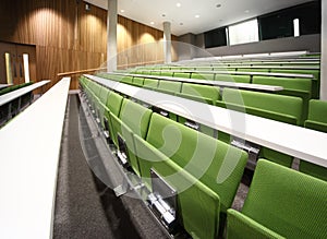 Auditorium with rows of seats and tables