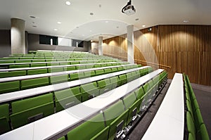 Auditorium with rows of seats and tables