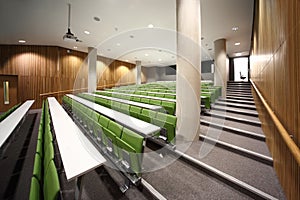 Auditorium with rows of seats and tables