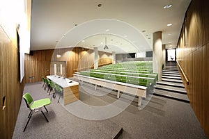 Auditorium with rows of seats and tables