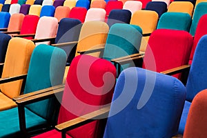 The auditorium in the theater. Multicolored spectator chairs