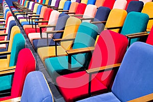 The auditorium in the theater. Multicolored spectator chairs