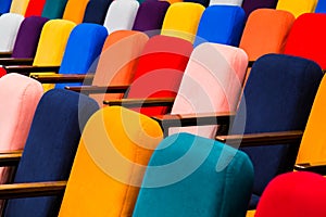 The auditorium in the theater. Multicolored spectator chairs