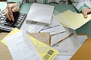 Audotir checking financial documents.Lot of office paper, documents, folders and woman sitting at the office desk
