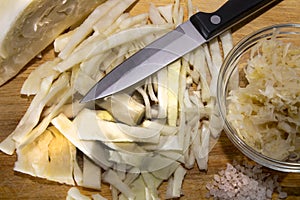 Auerkraut and sliced white cabbage with a knife