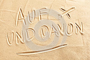 Auf und Davon with airplane on beach sand photo