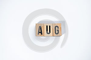 ` AUG ` text made of wooden cube on  White background