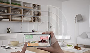 Augmented reality concept. Hand holding digital tablet smart phone use AR application to check information of calories in breakfas