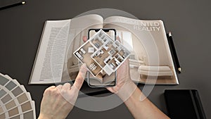 Augmented reality concept. Hand holding smartphone with AR application used to simulate 3d pop-up interactive house maps