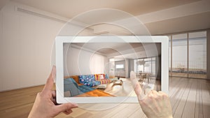 Augmented reality concept. Hand holding tablet with AR application used to simulate furniture and design products in empty photo