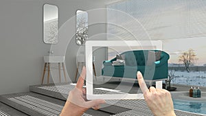 Augmented reality concept. Hand holding tablet with AR application used to simulate furniture and interior design products in real