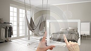 Augmented reality concept. Hand holding tablet with AR application used to simulate furniture and interior design products in real