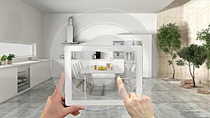 Augmented reality concept. Hand holding tablet with AR application used to simulate furniture and interior design products in real