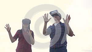 Augmented teamwork future reality device creating virtual space concept slow motion video. man and girl in virtual