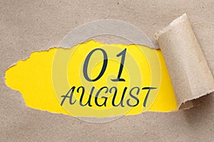 august 01. 01th day of the month, calendar date.Hole in paper with edges torn off. Yellow background is visible through