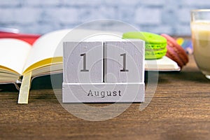 August 11 on the wooden calendar.The eleventh day of the summer month, a calendar for the workplace. Summer