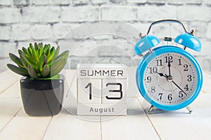 August 13 on the wooden calendar.The thirteenth day of the summer month, a calendar for the workplace. Summer