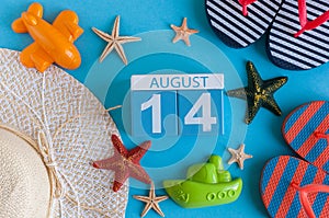 August 14th. Image of August 14 calendar with summer beach accessories and traveler outfit on background. Summer day