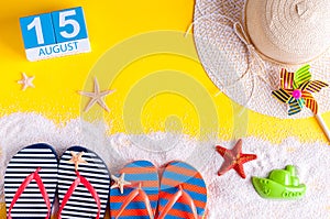 August 15th. Image of august 15 calendar with summer beach accessories and traveler outfit on background. Summer day