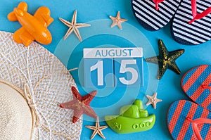 August 15th. Image of August 15 calendar with summer beach accessories and traveler outfit on background. Summer day